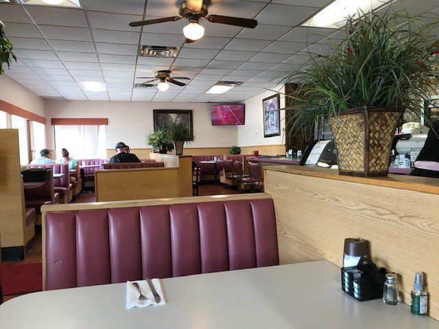 Family restaurant interior with simple table settings.