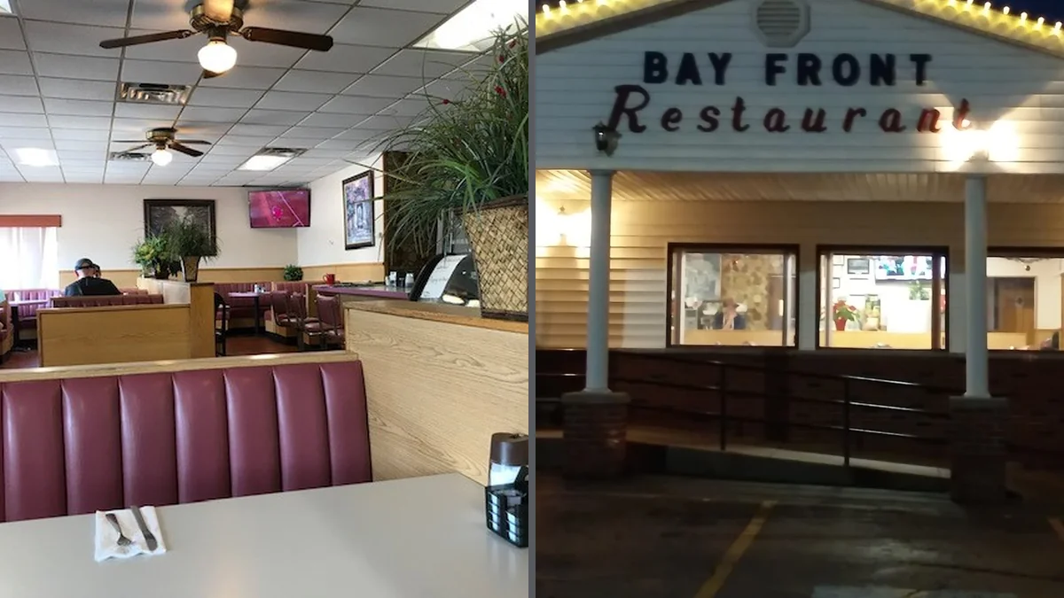 Clean dining area with booths and place settings.